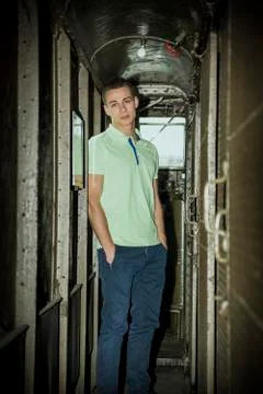 Young Man Standing with Hands in Pockets on Train Stock-Fotos