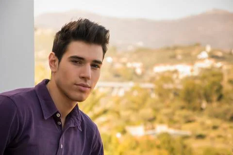 Young man standing looking over a rural landscape Stock Photos