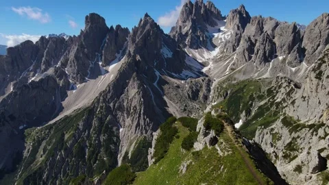 Young man standing on the mountain edge in Dolomites Stock Footage 193570205