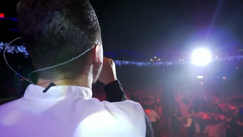 Young man standing on the stage and sing song before the public for peaple Stock Footage 101412595