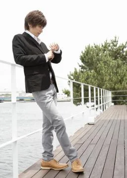 Young man standing on terrace Stock Photos