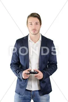 Young man standing, with videogame joypad in his hands Stock Photos