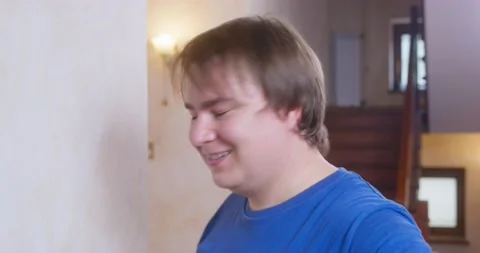 Young man stands up, appearing in the frame, shakes his head negatively and Video stock 169976672