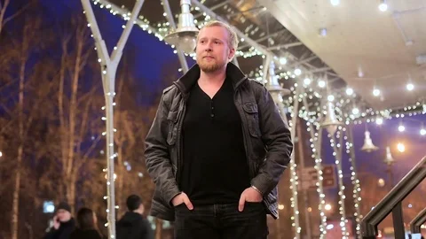 A young man stands on the background of night city Stock-Footage 75045339