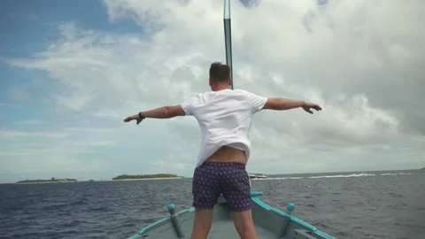 A young man stands at the bow of the ship Stock Footage 146887990