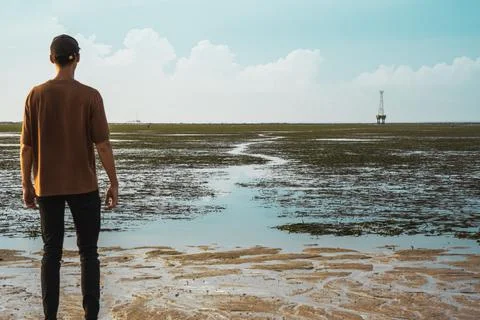 The young man stands on the choice of a difficult path in achieving the goal Stock Photos