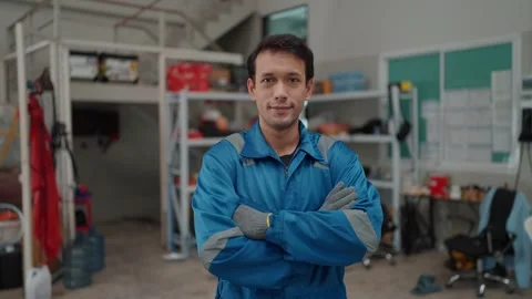 Young man stands confidently in a workshop Видео 338332506