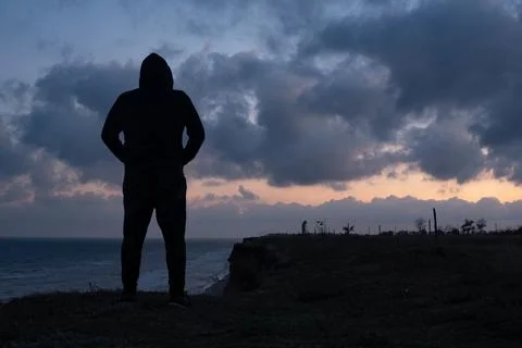 A young man stands on the edge Stock Photos
