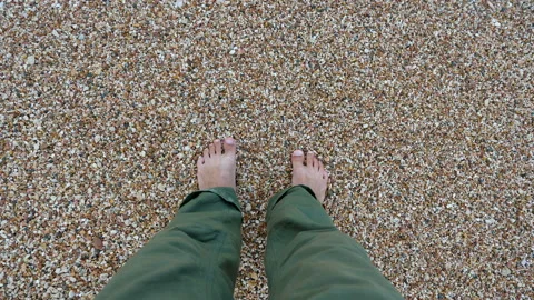 A young man stands on a sandy beach. Stock-Footage 98146874