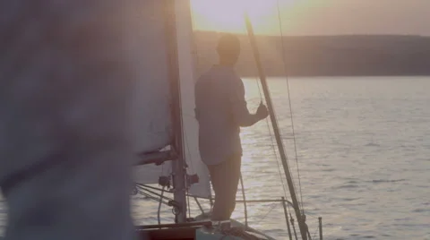Young man stands on a yacht in the morning looking into the distance 2 Stock Footage