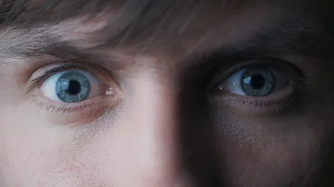 Young man stares at camera with blue eyes Stock-Footage 73024157