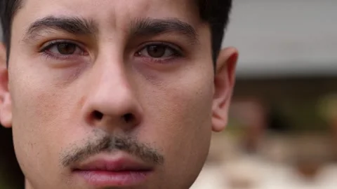 Young man stares into the camera with serious expression Stock Footage 306680396