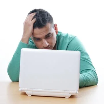 Young man staring at netbook Stock Photos