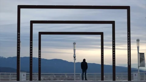 Young man staring into the sunset while seeing mountains and ocean Video stock 150240292