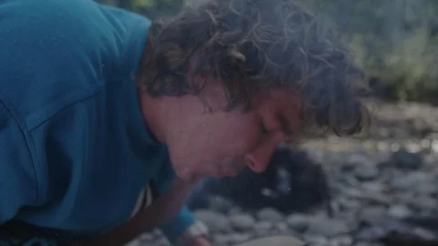 Young man is starting a fire Video stock 76739633