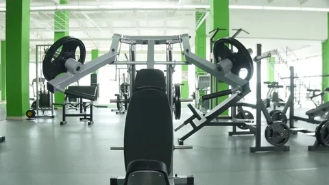 Young man starting to flexing chest muscles on gym machine Stock Footage