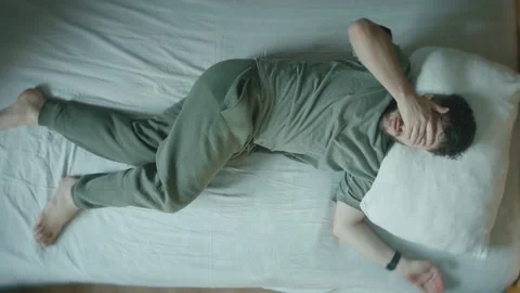 Young Man Startled Awake From Sleep, Jolting In Bed At Home Stock Footage 344095125