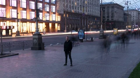 Young man stay without moving  in evening time. Smashed crowd of people. Stock Footage 73988501