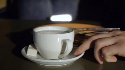 Young man stirring tea with spoon Stock Footage 70864205
