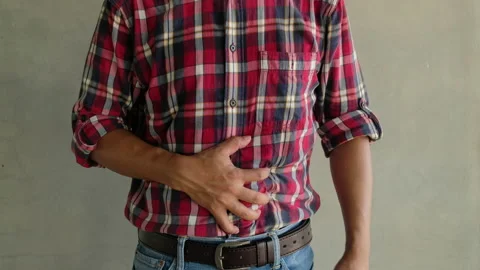 A young man with a stomachache Stock Footage 153155382