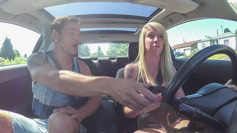Young man stops girlfriend from texting and driving Stock Footage 92227428