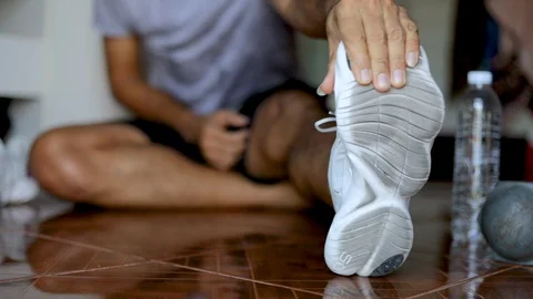 Young man stretches the body before exercise Video stock 128745310