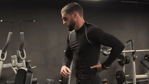 Young man stretching back muscles after exercising, having ache Video stock 102763404