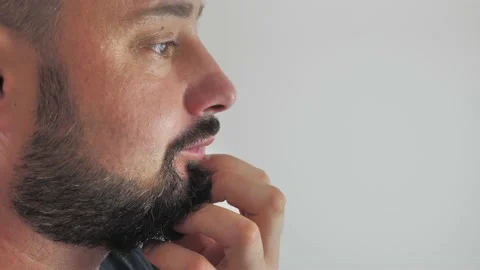 Young man strokes his beard. Stock Footage 203977500