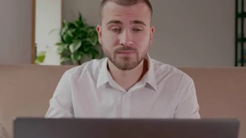 Young man strongly doubts looking at laptop Stock Footage 159898222