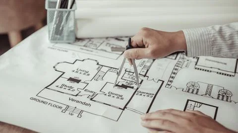 Young man  structural design or engineer is using a measuring circle around a Stock Photos
