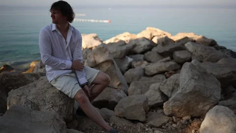 Young man struggles to relax on vacation after constant work and busy routine Stock Footage 341622800