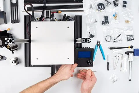 Young man student assembly of 3D printer building kit Stock Photos