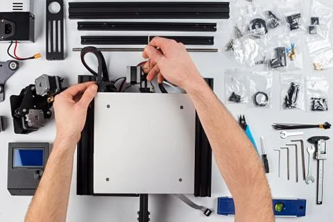 Young man student assembly of 3D printer building kit Stock Photos