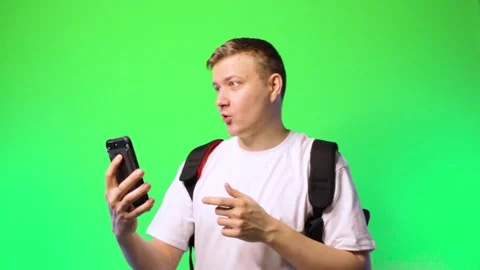 Young man student communicates via video call flirting dating chroma key Stock Footage 170571112