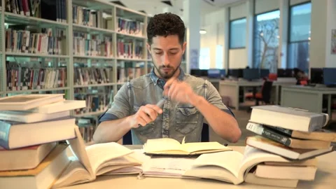 Young Man student study in the library reading book. Stock Footage 139483798