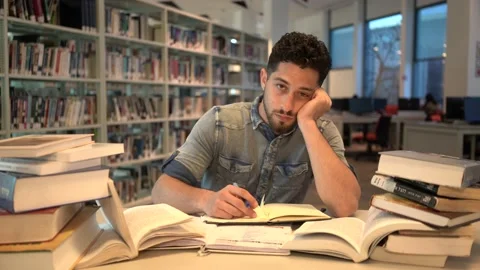 Young Man student study in the library reading book. Stock Footage 139483808
