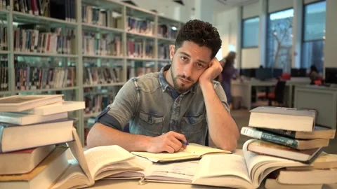 Young Man student study in the library reading book. Stock Footage 139483818