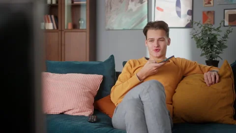 Young man student using smartphone, making voice message, smiling, communicating Stock Footage 153091500