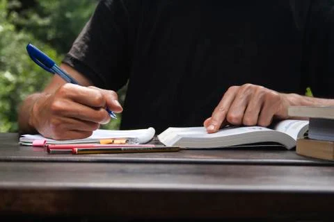 Young man studing and taking notes Stock Photos