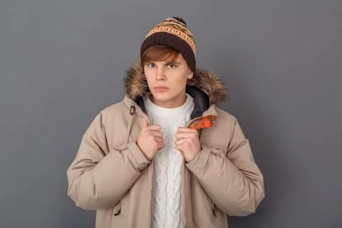 Young man studio isolated on grey winter style looking camera confident Stock Photos