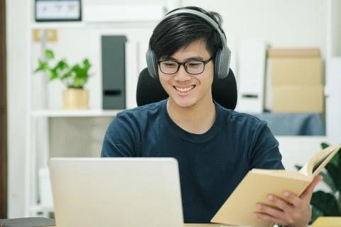 Young man study in front of the laptop computer at home Stock Photos