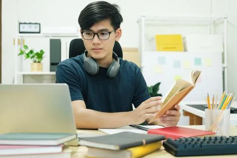 Young man study in front of the laptop computer at home Stock Photos