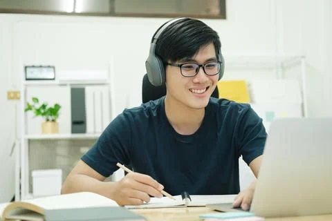 Young man study in front of the laptop computer at home Stock Photos