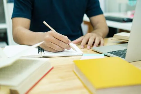 Young man study in front of the laptop computer at home Stock Photos