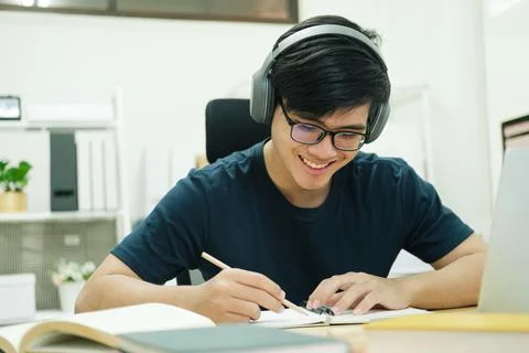 Young man study in front of the laptop computer at home Stock Photos
