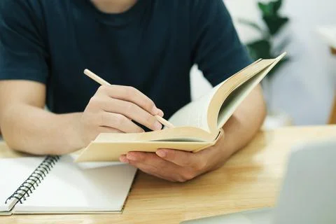 Young man study in front of the laptop computer at home. Stock Photos