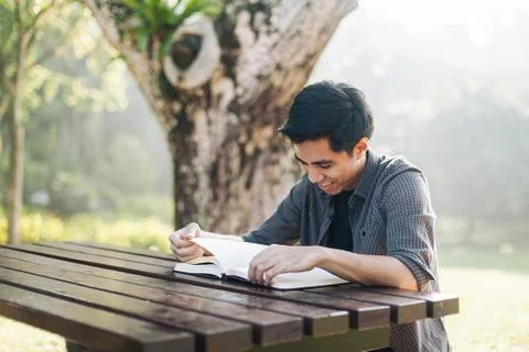 Young man studying alone at a park Stock Photos