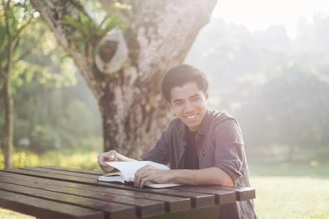 Young man studying alone at a park Stock Photos