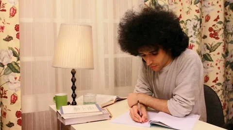 Young man studying and writing on the book Video stock 3451972