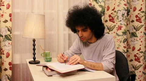 Young man studying on the book Stock Footage 3433748